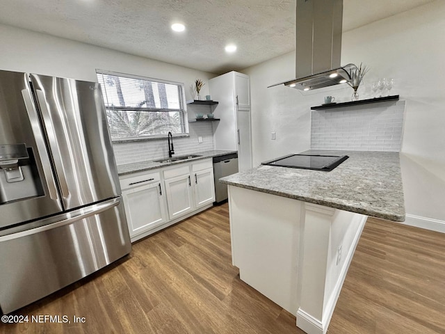 kitchen with stainless steel appliances, island range hood, sink, light hardwood / wood-style flooring, and white cabinets