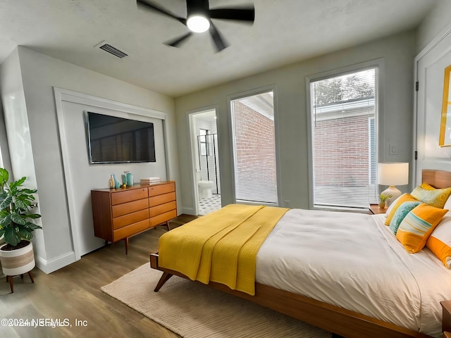 bedroom with ceiling fan, light hardwood / wood-style floors, and connected bathroom