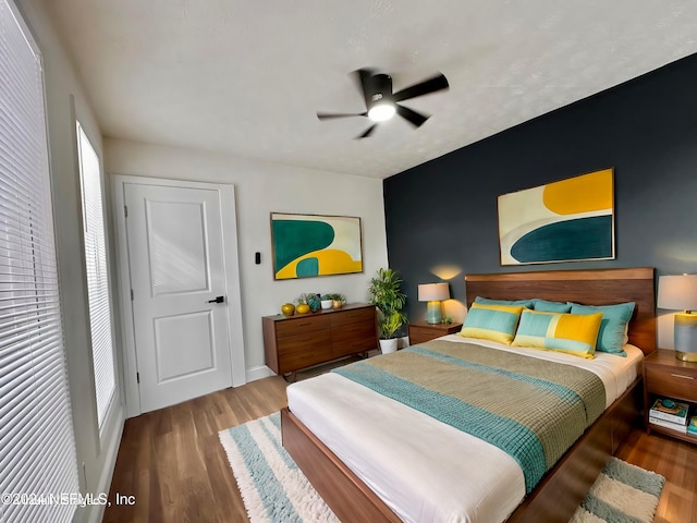 bedroom featuring wood-type flooring and ceiling fan