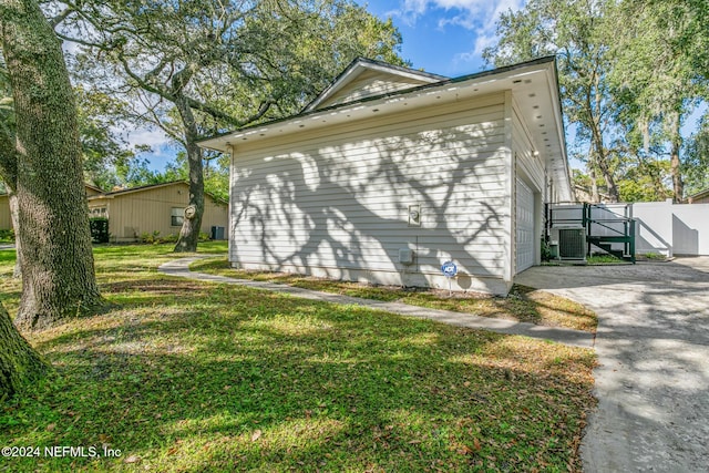 view of home's exterior with a yard and central AC unit