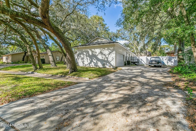 view of property exterior featuring a garage and a yard