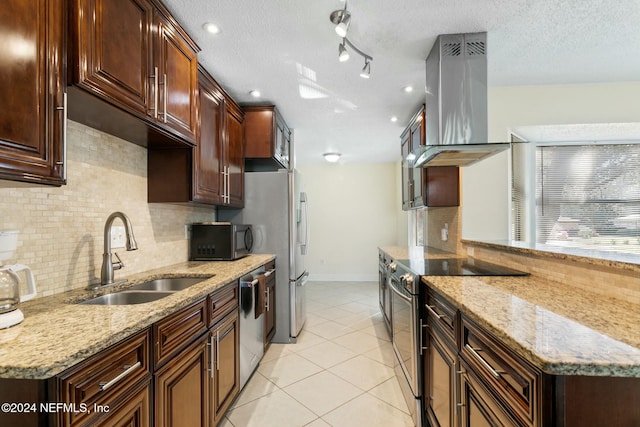 kitchen featuring backsplash, ventilation hood, sink, light stone counters, and stainless steel appliances