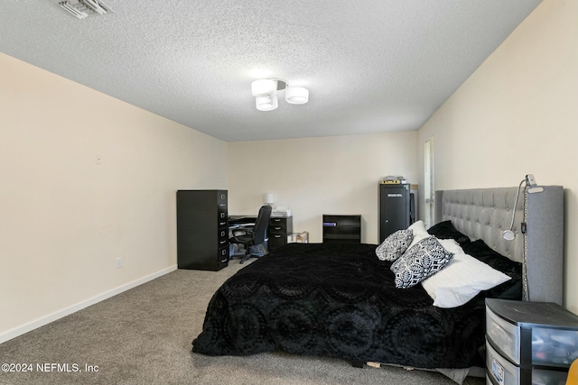 carpeted bedroom featuring a textured ceiling