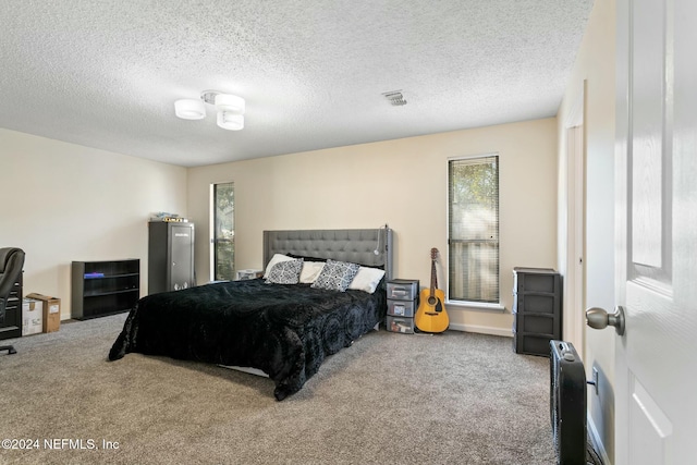 bedroom featuring a textured ceiling and carpet floors