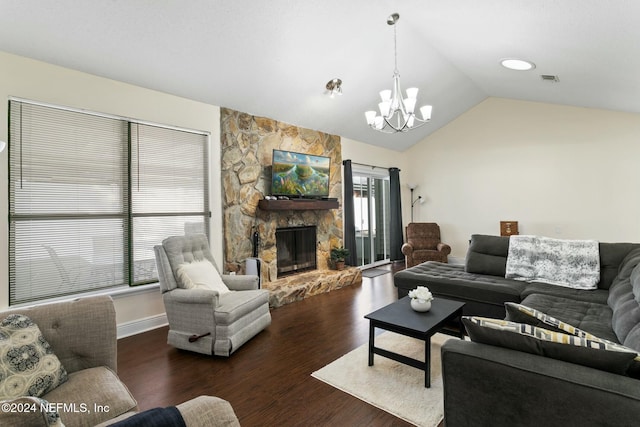 living room with a stone fireplace, dark wood-type flooring, lofted ceiling, and a notable chandelier