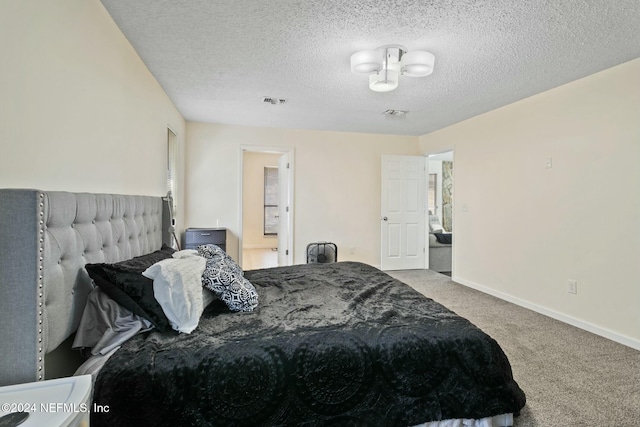 carpeted bedroom featuring a textured ceiling