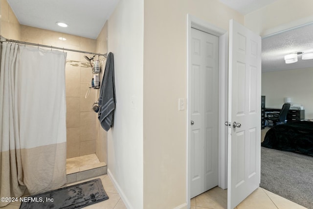 bathroom featuring tile patterned floors, a textured ceiling, and walk in shower