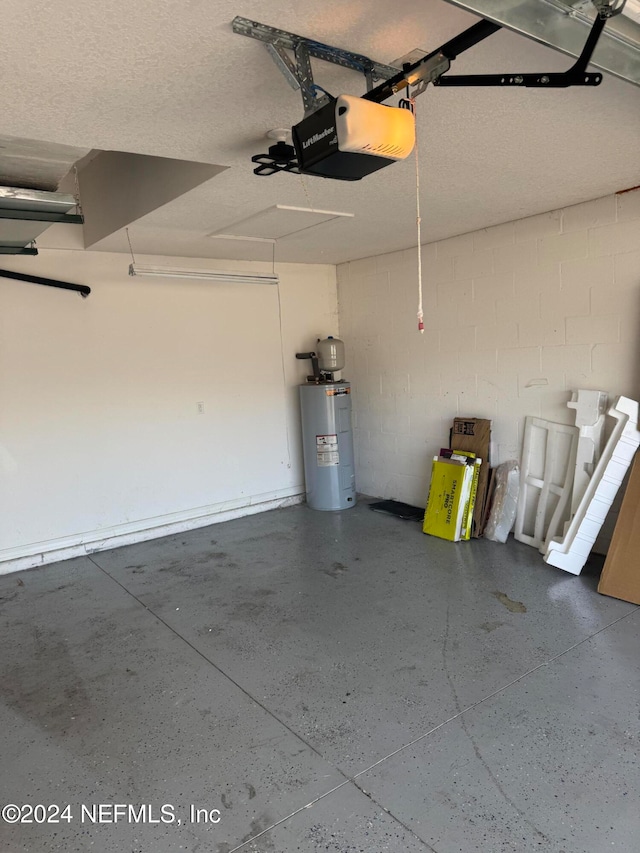 garage featuring water heater and a garage door opener