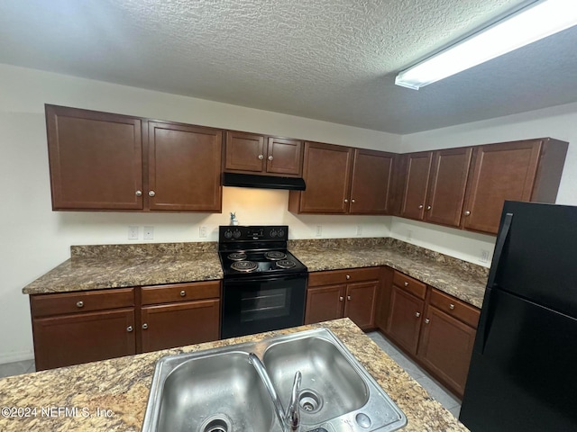 kitchen featuring black appliances, a textured ceiling, dark brown cabinets, sink, and dark stone countertops