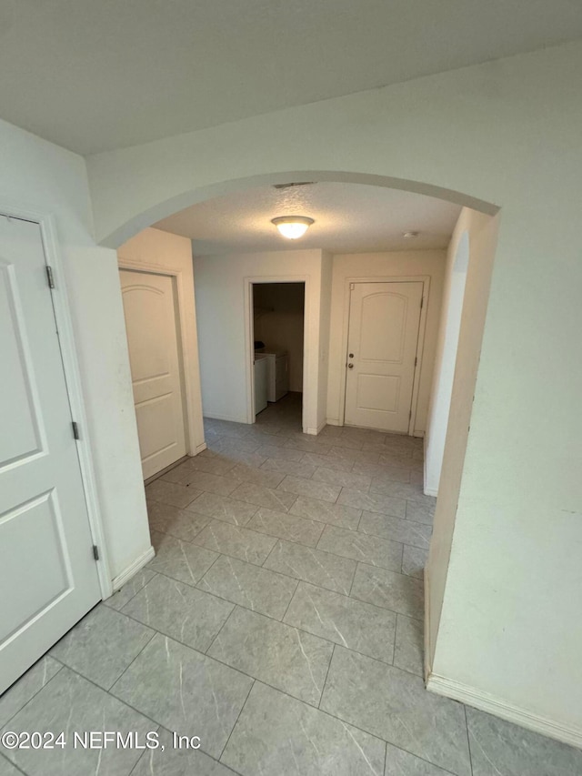 hall with light tile patterned floors