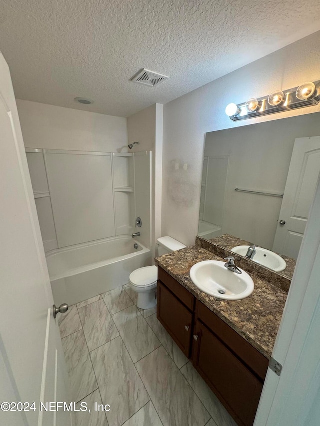 full bathroom featuring toilet, vanity, shower / bathtub combination, and a textured ceiling