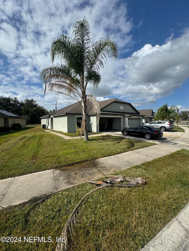 view of front of property with a garage and a front lawn