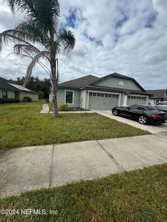 view of front of house with a front lawn and a garage