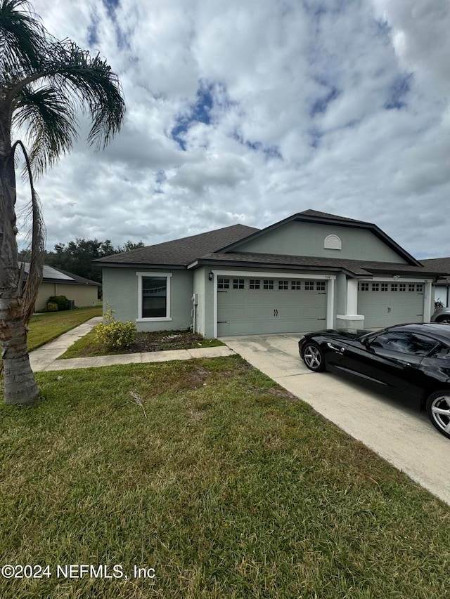 view of front of property featuring a garage and a front yard