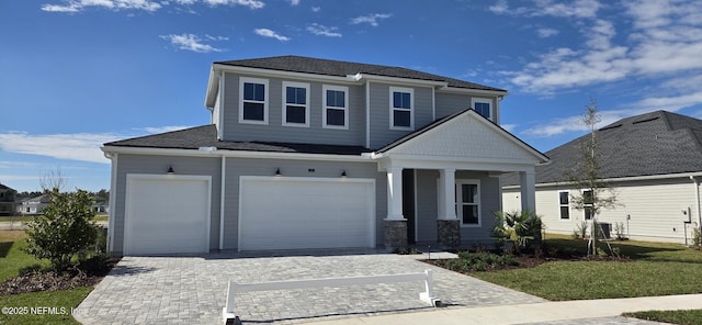 view of front of home featuring central AC and decorative driveway