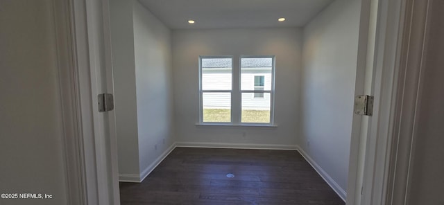 empty room featuring recessed lighting, dark wood finished floors, and baseboards