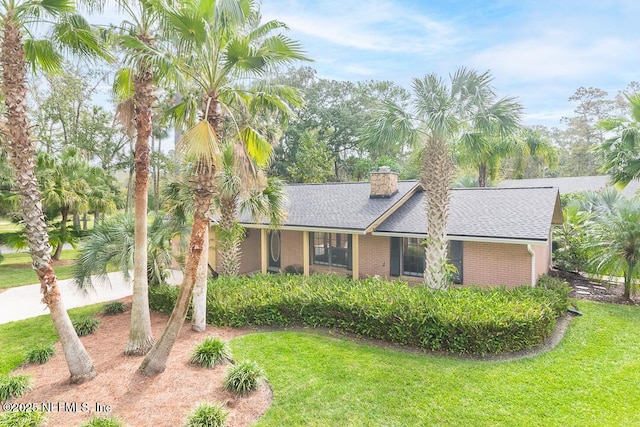 ranch-style home featuring a front yard