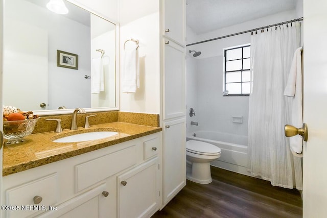 bathroom featuring toilet, shower / bathtub combination with curtain, wood finished floors, and vanity