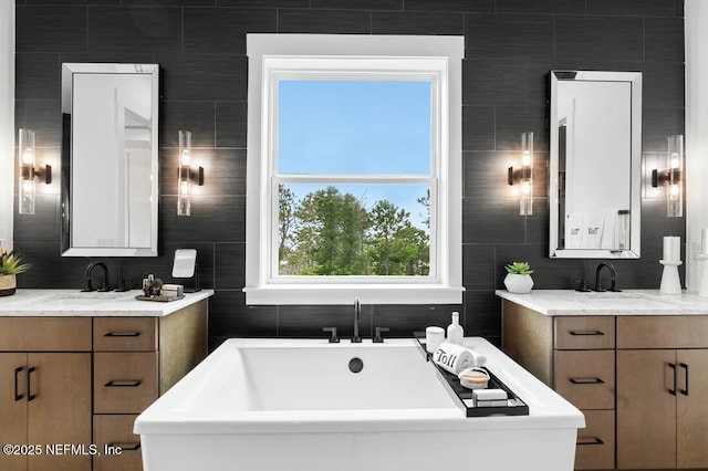 300 Hillendale Cir, Saint Johns, FL 32259 - full bath with a sink, a freestanding tub, two vanities, and tile walls