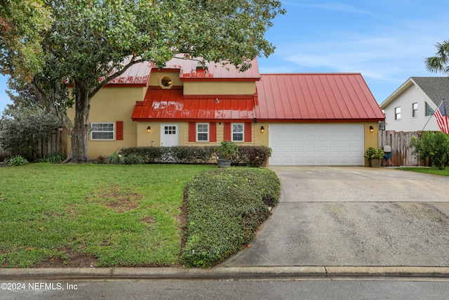 view of front of house with a front yard and a garage