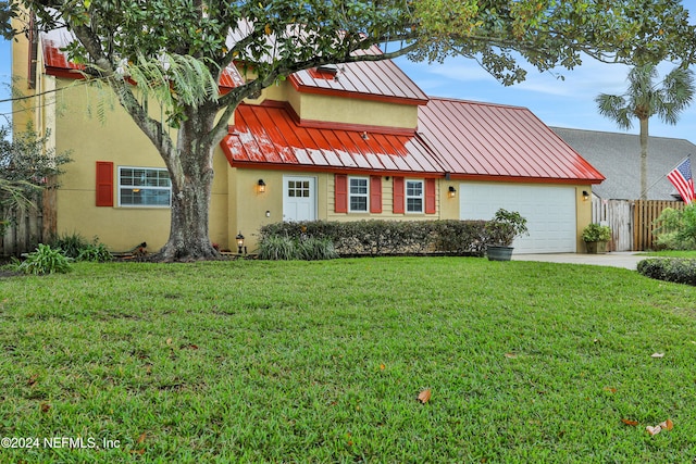 view of front of property featuring a front lawn and a garage