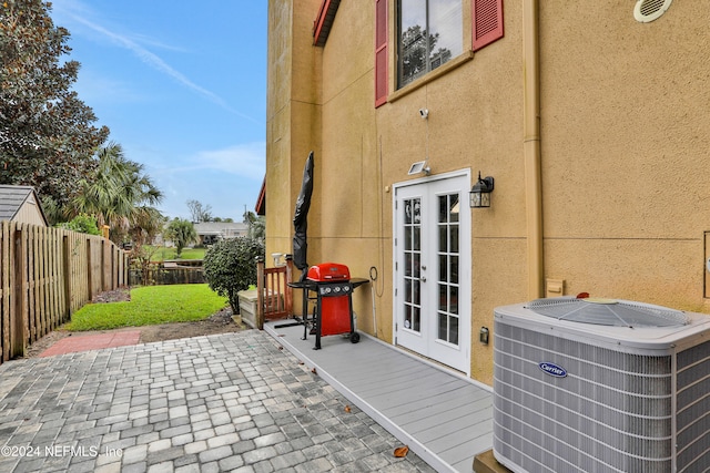 view of patio with french doors, grilling area, and central AC unit