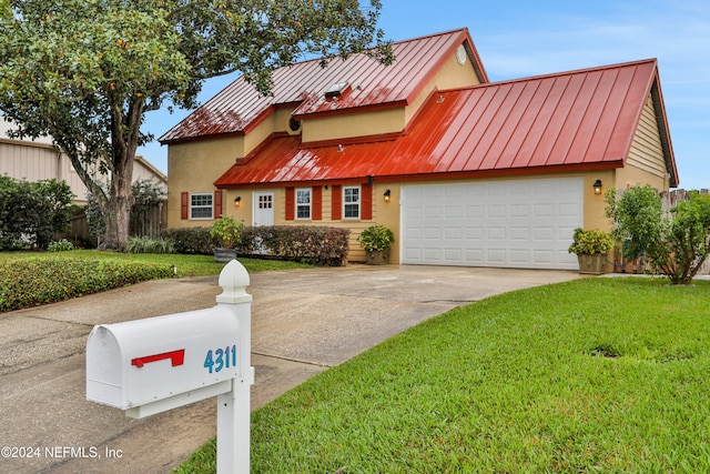 view of front of home featuring a front lawn and a garage