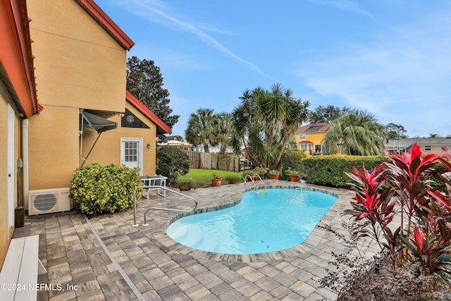 view of pool with ac unit and a patio area