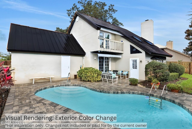 rear view of property with a patio area, a balcony, and a fenced in pool