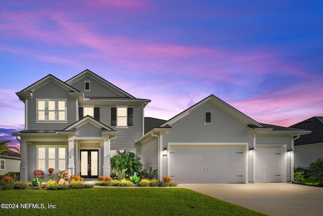 view of front of home featuring a garage and a yard