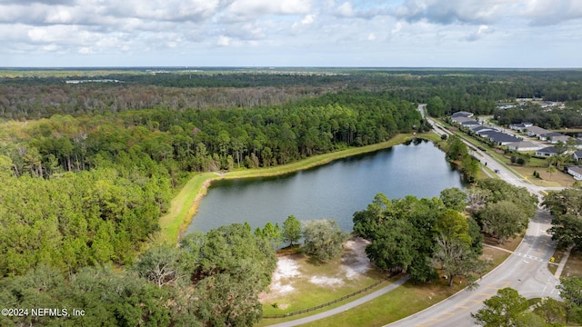 view of property location featuring a forest and a large body of water