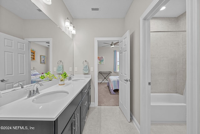 bathroom with tile patterned flooring, ceiling fan, vanity, and tiled shower / bath combo