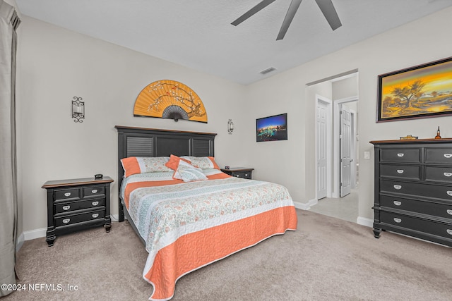 bedroom featuring light carpet and ceiling fan