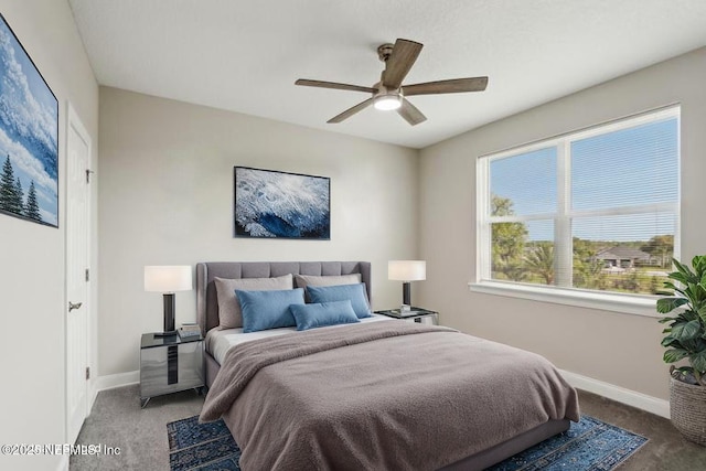 carpeted bedroom featuring baseboards and ceiling fan