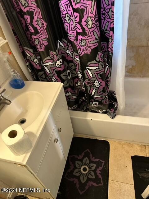 bathroom with vanity, shower / bath combination with curtain, and tile patterned flooring