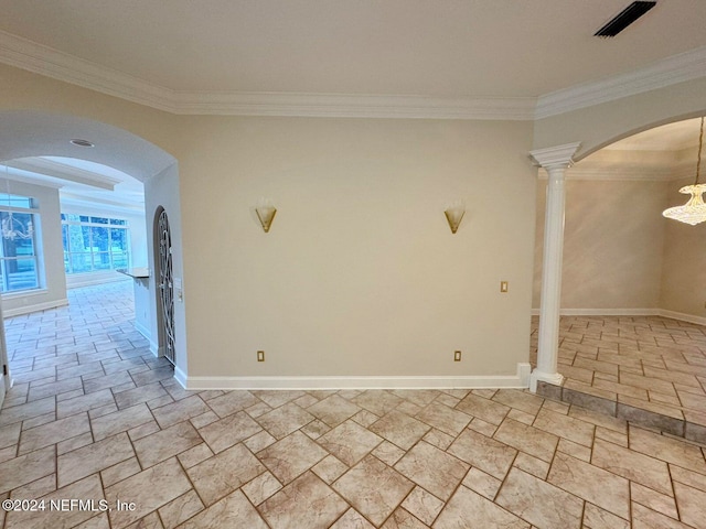 empty room featuring ornate columns and crown molding