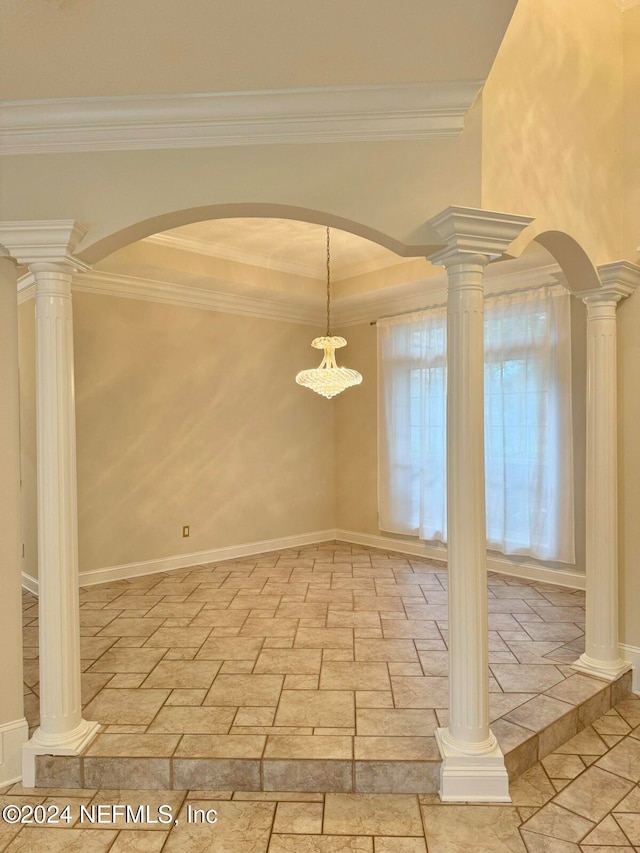 unfurnished dining area featuring a raised ceiling and crown molding