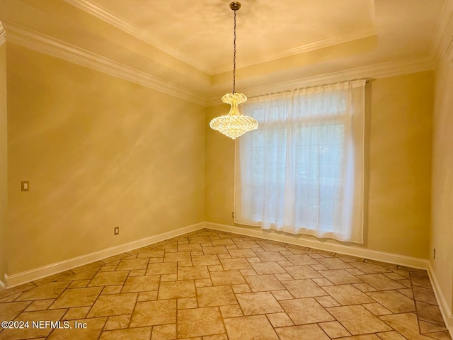 spare room featuring a tray ceiling, crown molding, and a chandelier