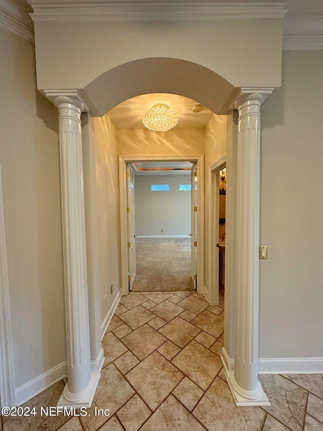 corridor featuring ornamental molding and ornate columns