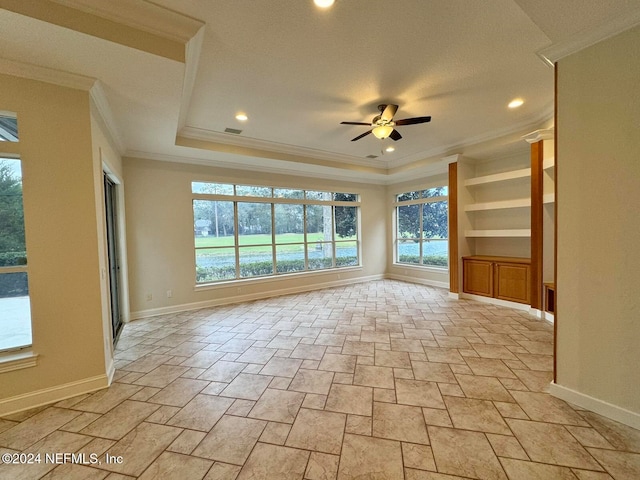 spare room with ceiling fan and crown molding