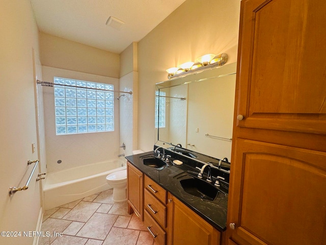 full bathroom with vanity, tiled shower / bath combo, and toilet