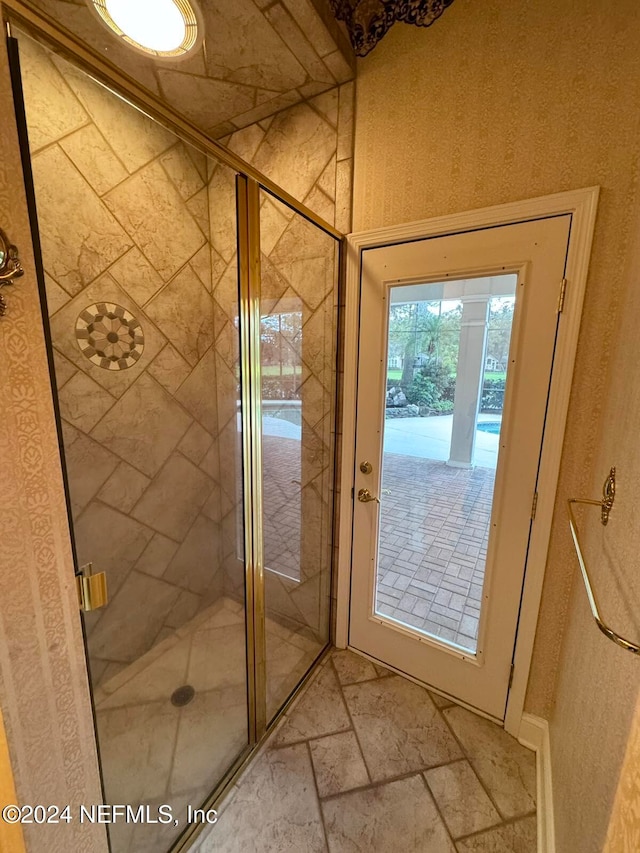 bathroom with a shower with door