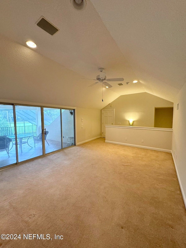 bonus room featuring carpet, a textured ceiling, vaulted ceiling, and ceiling fan