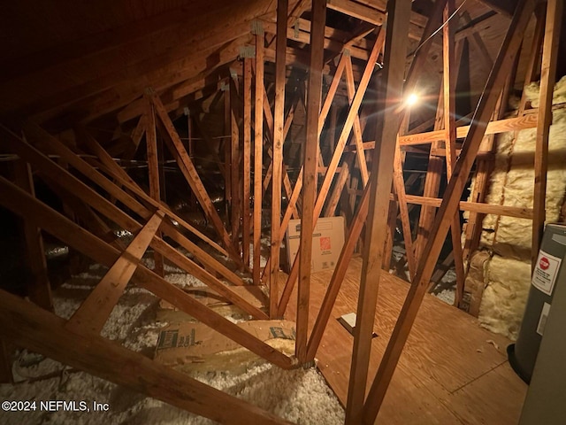 unfinished attic with water heater