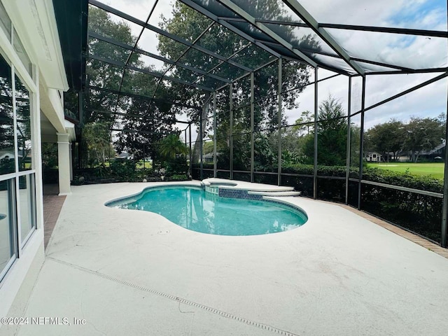 view of swimming pool with glass enclosure, a patio area, and an in ground hot tub