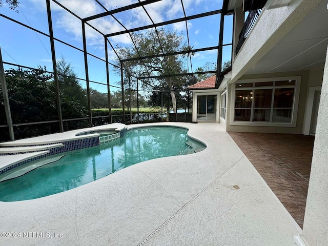 view of pool with an in ground hot tub, a patio, and a lanai