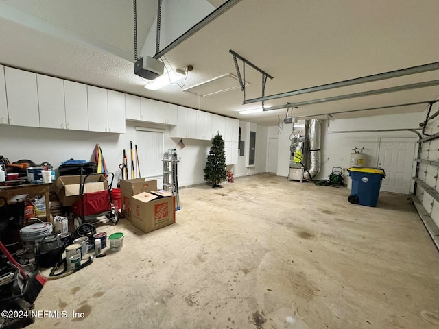 garage featuring heating unit and a garage door opener