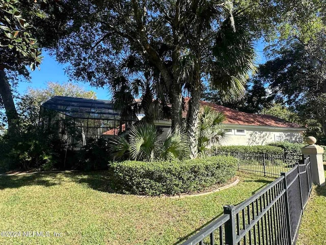 view of yard featuring glass enclosure