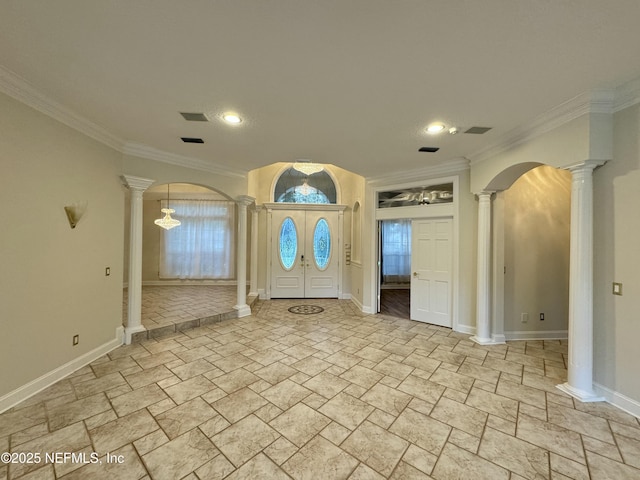 foyer featuring crown molding and ornate columns