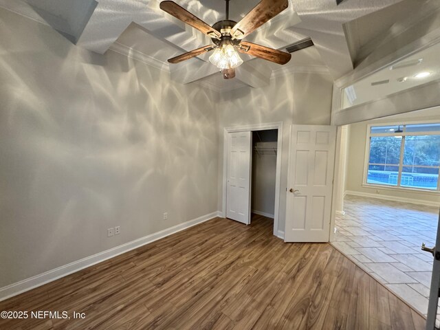 unfurnished bedroom with hardwood / wood-style flooring and a closet